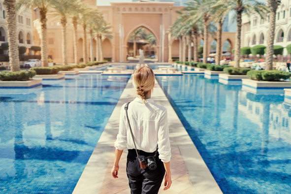 Woman with camera walking in downtown Dubai