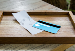 Bank card on tray with receipt