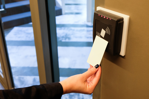 Woman tapping RFID card to access building