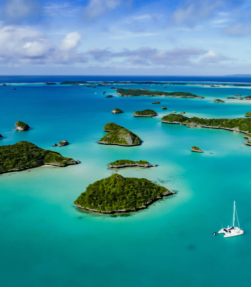 A spectacular drone image over Falaga Island in the lower Lau Group, Fiji showing a catamaran peacefully at anchor.