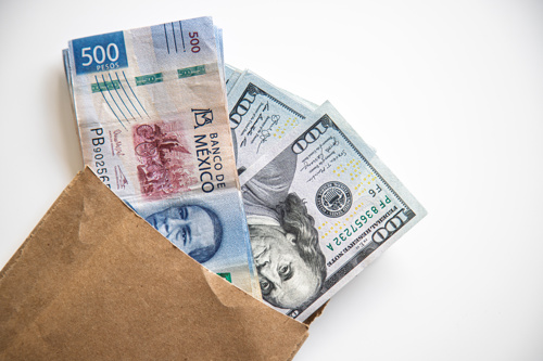 flat lay of currency including Mexican pesos and US dollars